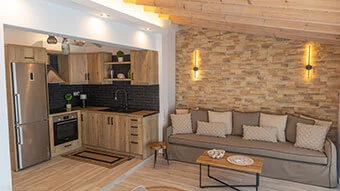 Upon entrance, you will love the traditional stone wall sitting between the kitchen and the water