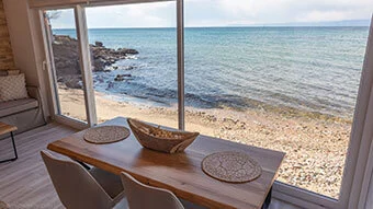 The sitting table inside the apartment is one and a half meter long and has enough space for all guests to be sitting and facing the Aegean