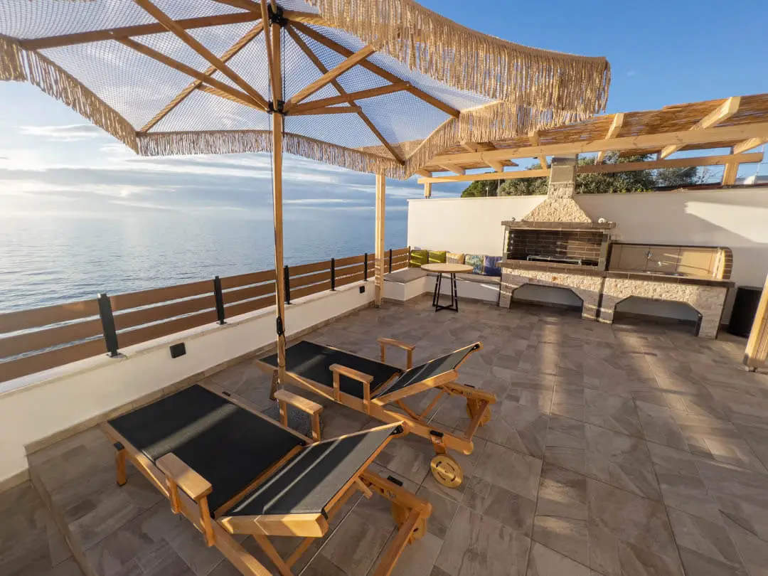 A panoramic view over the sitting area and the Aegean in front