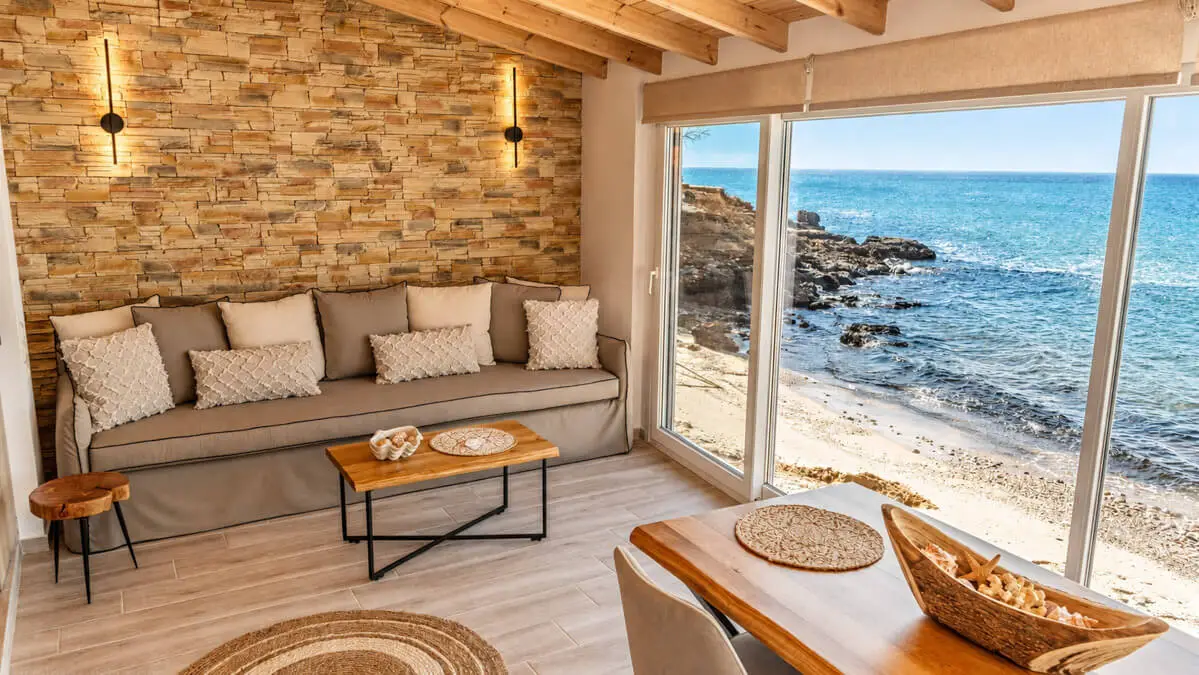 Upon entrance, you will love the traditional stone wall sitting between the kitchen and the water