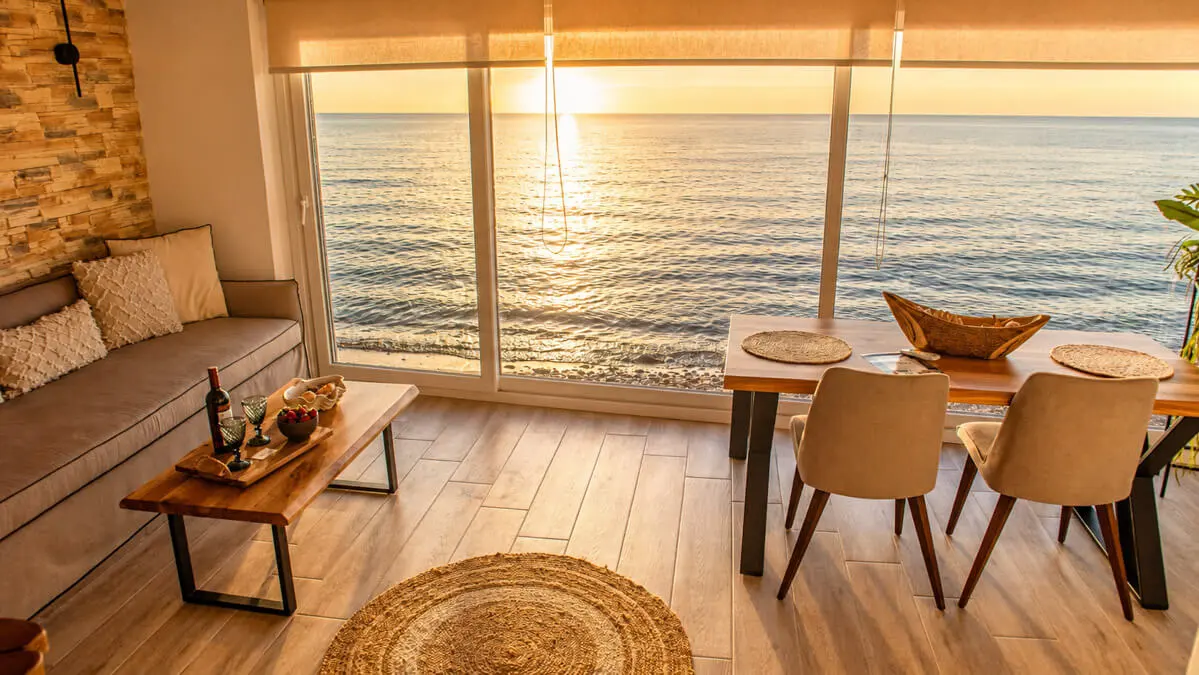 A sitting table right next to the waves and where the seagulls meet
